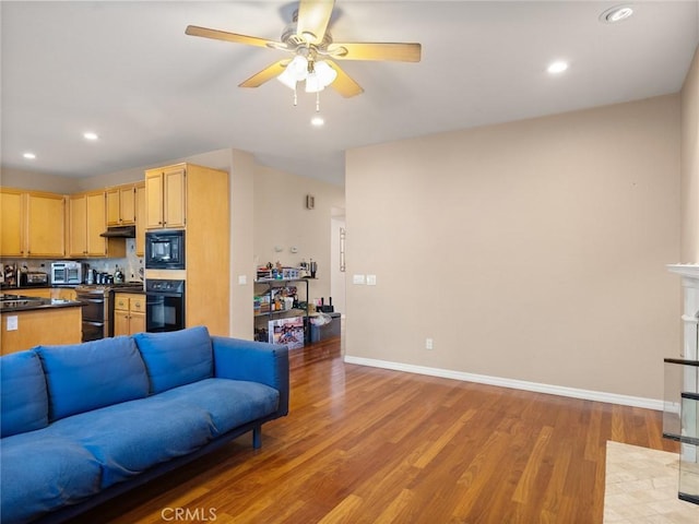 living room with light wood-type flooring, baseboards, a ceiling fan, and recessed lighting