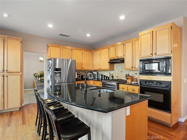 30514 Sorrento Pl, Castaic, CA 91384 - kitchen featuring black appliances, under cabinet range hood, light brown cabinets, light wood-type flooring, and recessed lighting