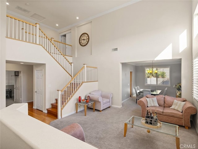 30514 Sorrento Pl, Castaic, CA 91384 - carpeted living area featuring a high ceiling, stairway, crown molding, a chandelier, and recessed lighting