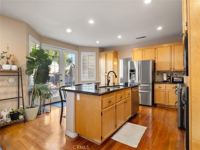 30514 Sorrento Pl, Castaic, CA 91384 - kitchen featuring stainless steel appliances, dark countertops, an island with sink, dark wood-style floors, and recessed lighting