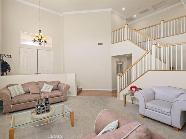 30514 Sorrento Pl, Castaic, CA 91384 - carpeted living room featuring a high ceiling, a chandelier, stairs, ornamental molding, and recessed lighting