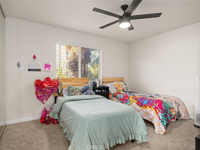 bedroom with carpet floors, ceiling fan, and baseboards