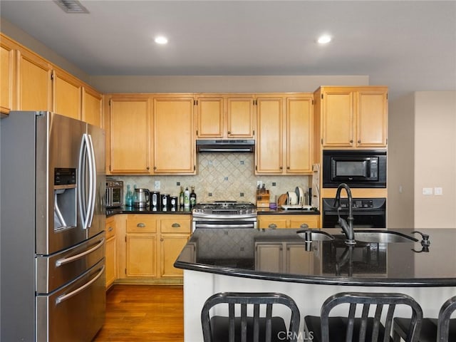 kitchen with decorative backsplash, appliances with stainless steel finishes, dark wood-type flooring, under cabinet range hood, and recessed lighting