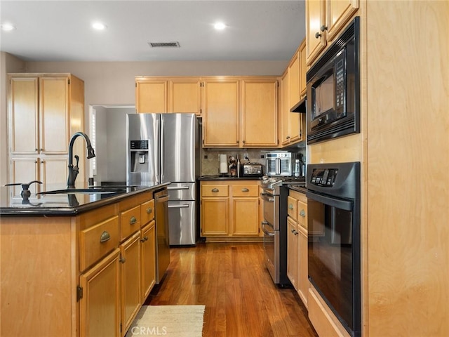 30514 Sorrento Pl, Castaic, CA 91384 - kitchen with black appliances, dark countertops, dark wood-style flooring, light brown cabinetry, and recessed lighting