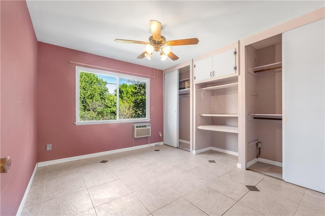 unfurnished bedroom featuring light tile patterned floors, ceiling fan, baseboards, and an AC wall unit