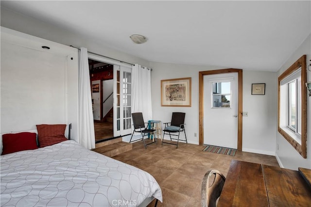 bedroom with baseboards, vaulted ceiling, and french doors