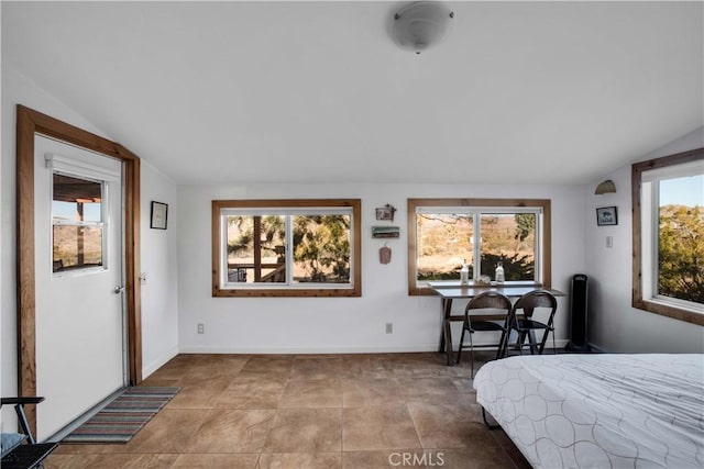 bedroom with vaulted ceiling and baseboards