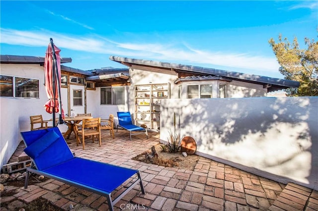 view of patio / terrace featuring outdoor dining area and fence