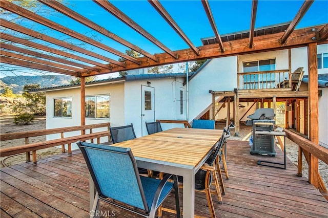 wooden terrace with outdoor dining space