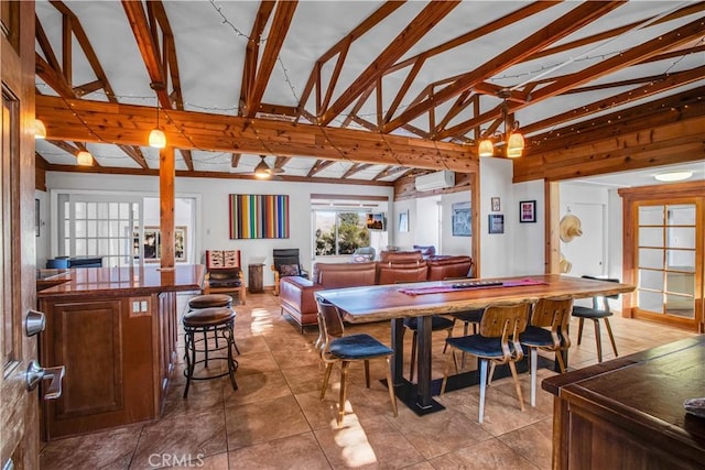 tiled dining space with vaulted ceiling with beams and a wall mounted air conditioner