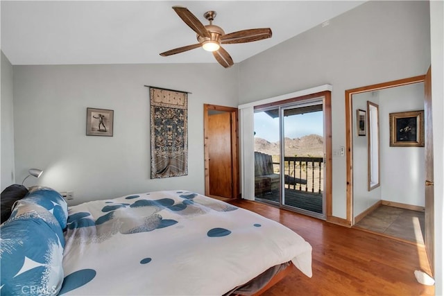 bedroom with access to exterior, lofted ceiling, ceiling fan, wood finished floors, and baseboards