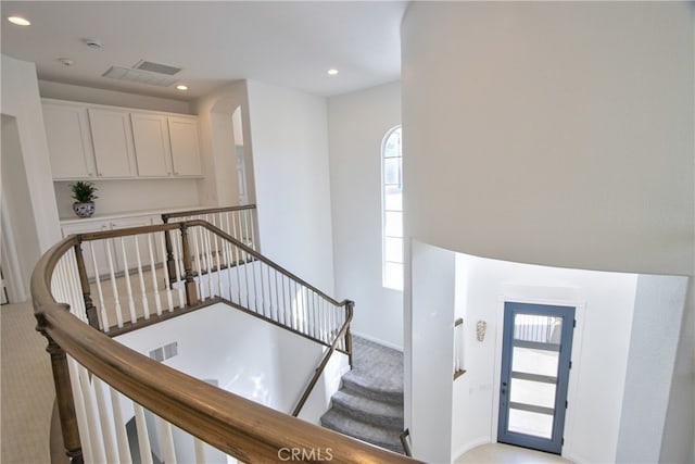 staircase with recessed lighting, visible vents, and carpet