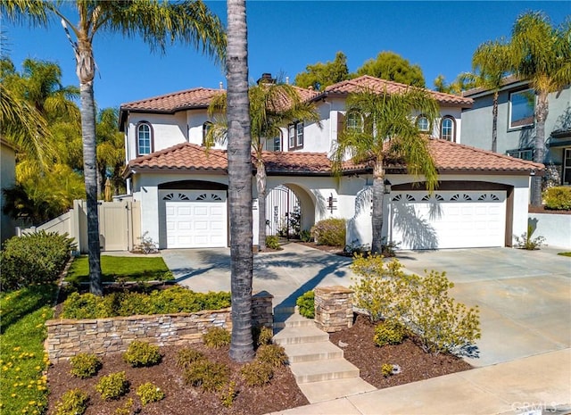 mediterranean / spanish home with stucco siding, driveway, a chimney, and a garage