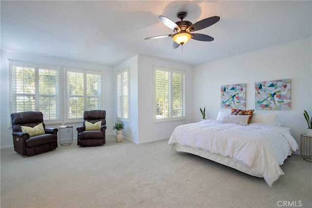 carpeted bedroom featuring baseboards and ceiling fan