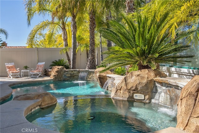 view of pool with a fenced in pool and fence