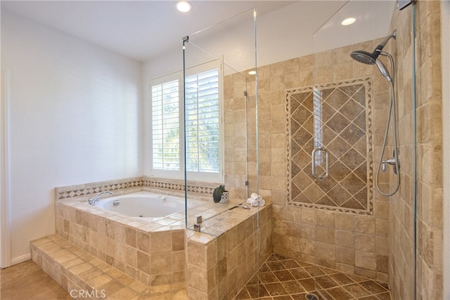 full bathroom with a shower stall, a bath, and recessed lighting