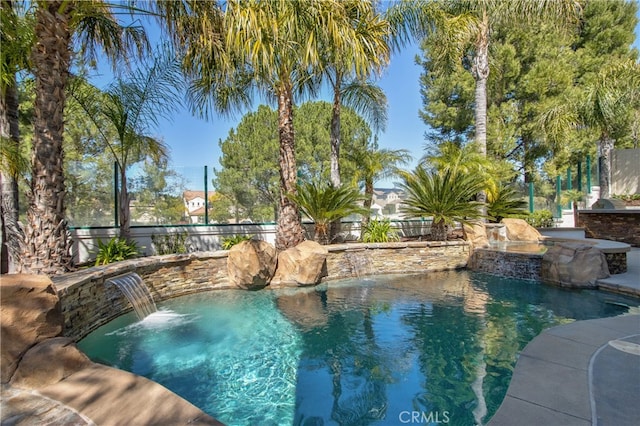 view of swimming pool with a fenced in pool and fence