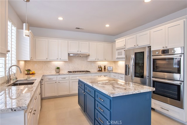 kitchen featuring visible vents, a sink, appliances with stainless steel finishes, white cabinetry, and blue cabinets