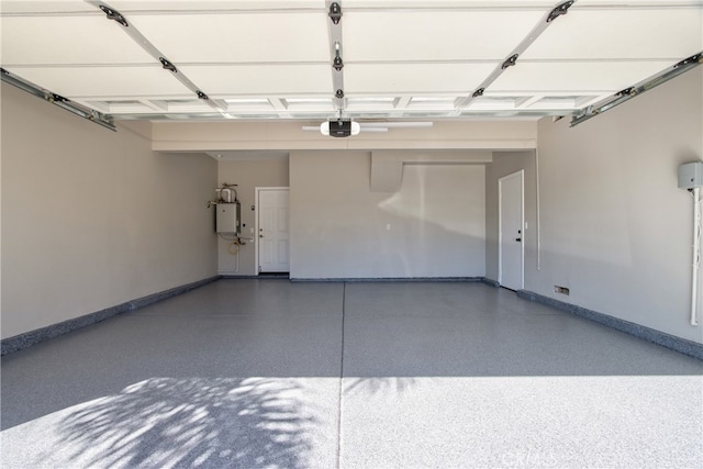 garage with baseboards, a garage door opener, and water heater