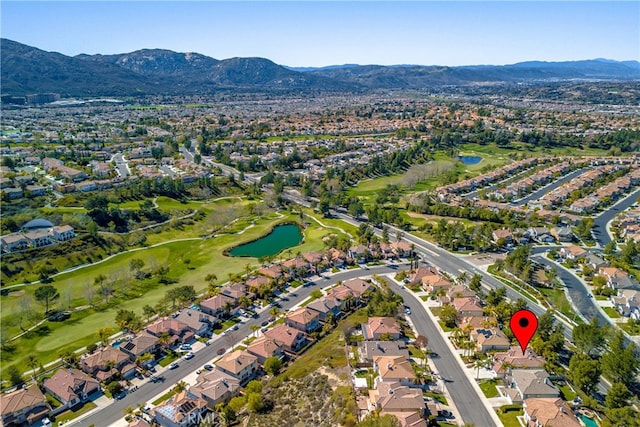 drone / aerial view with a residential view, a water and mountain view, and golf course view