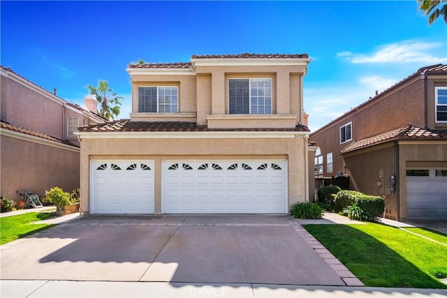 view of front of home with a garage, concrete driveway, a tiled roof, and stucco siding