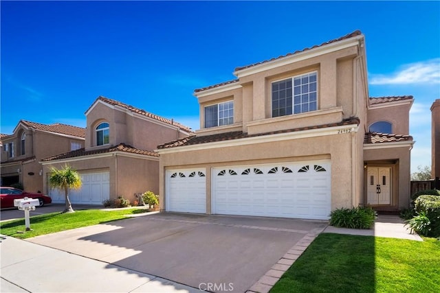 mediterranean / spanish-style home featuring driveway, an attached garage, a tile roof, and stucco siding