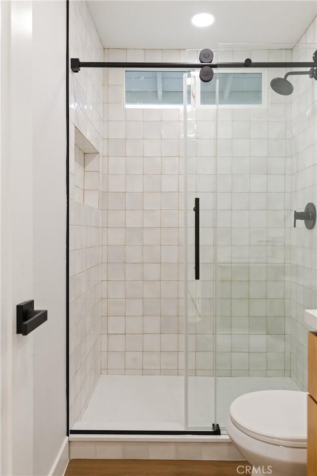 full bath with a shower stall and toilet