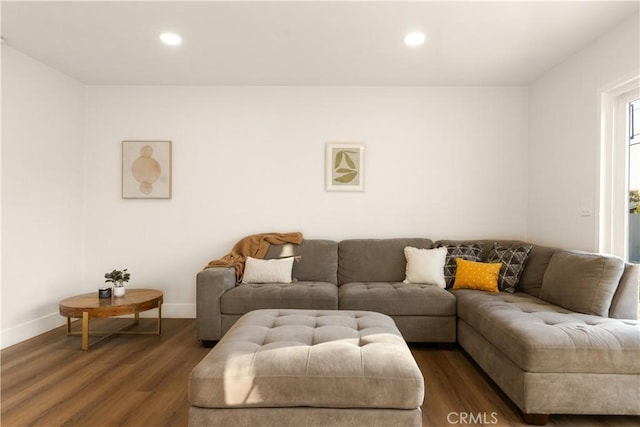 living area with recessed lighting, dark wood-style flooring, and baseboards