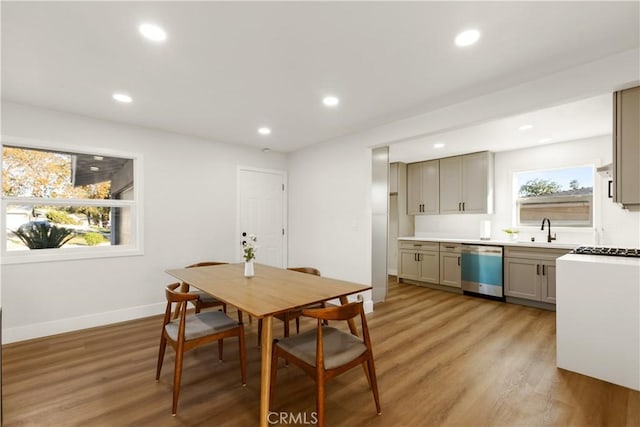 dining room with recessed lighting, light wood-style flooring, and baseboards