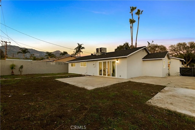 back of property featuring a patio, a fenced backyard, central AC, french doors, and stucco siding