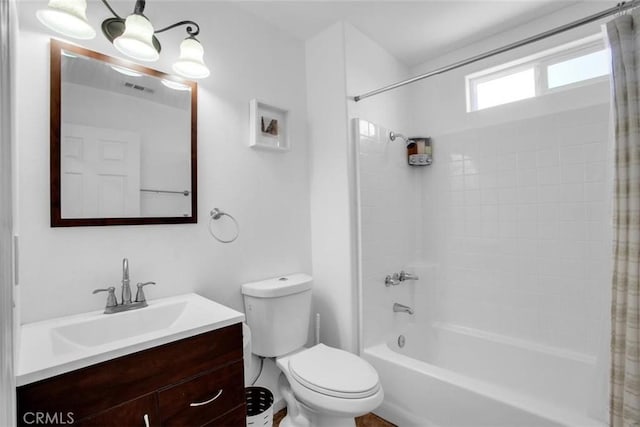 full bathroom with toilet, shower / bath combo, visible vents, and vanity