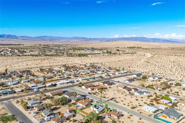 birds eye view of property featuring a mountain view and a desert view