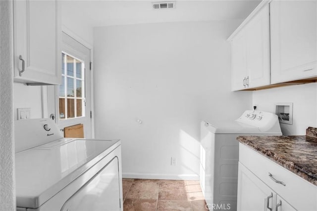 laundry area featuring independent washer and dryer, cabinet space, visible vents, and baseboards