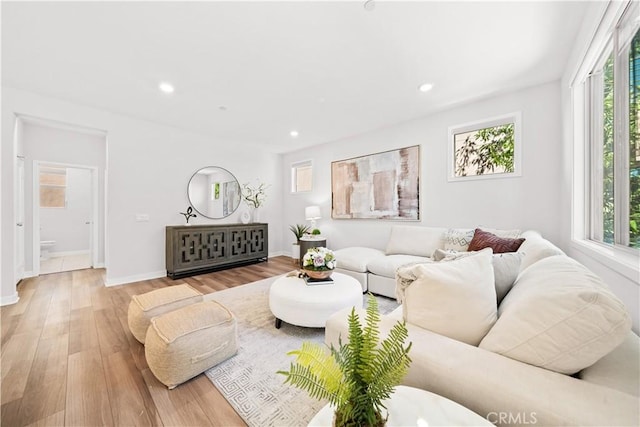 living room featuring recessed lighting, baseboards, and wood finished floors