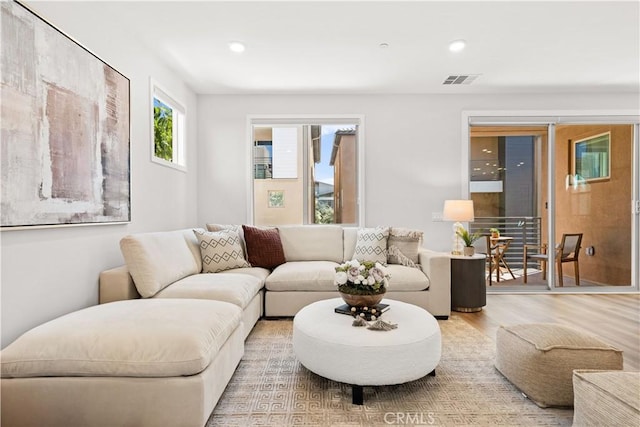 living area featuring wood finished floors, visible vents, and recessed lighting