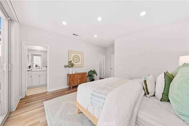 bedroom featuring baseboards, visible vents, connected bathroom, light wood-style floors, and recessed lighting