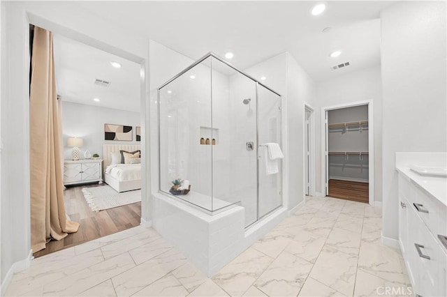 ensuite bathroom with marble finish floor, visible vents, connected bathroom, and recessed lighting