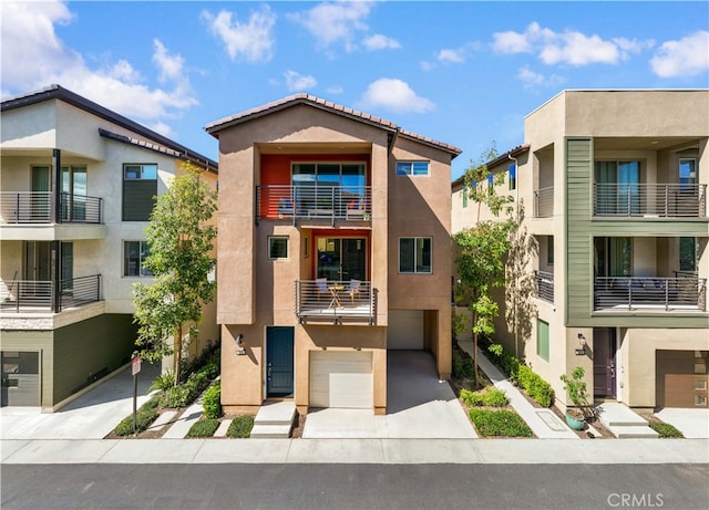 view of front of house featuring concrete driveway, an attached garage, and stucco siding