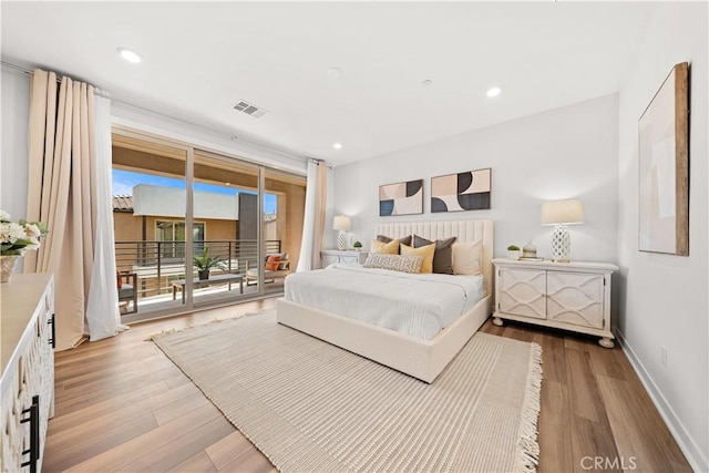 bedroom with access to outside, light wood-type flooring, visible vents, and baseboards