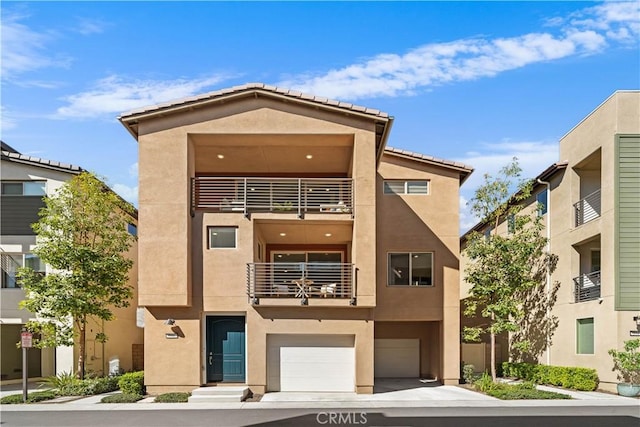 view of front of home featuring an attached garage and stucco siding