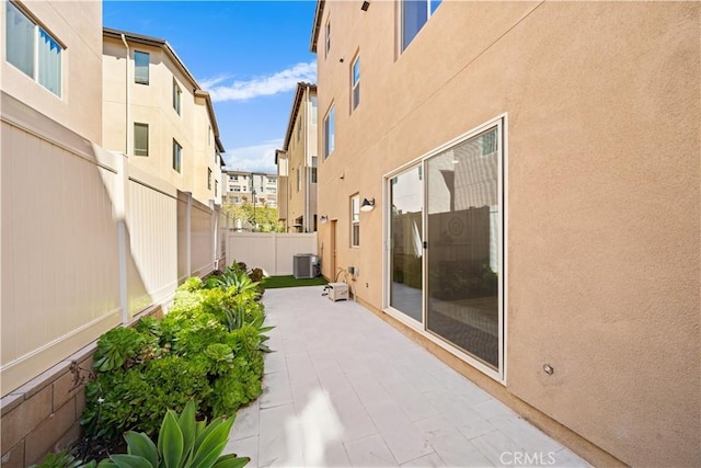 view of patio / terrace with a fenced backyard and central AC unit