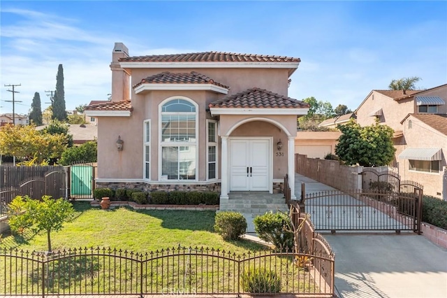 mediterranean / spanish-style home featuring stone siding, a gate, a chimney, and stucco siding