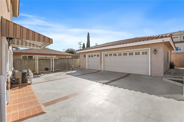 garage featuring fence and central air condition unit