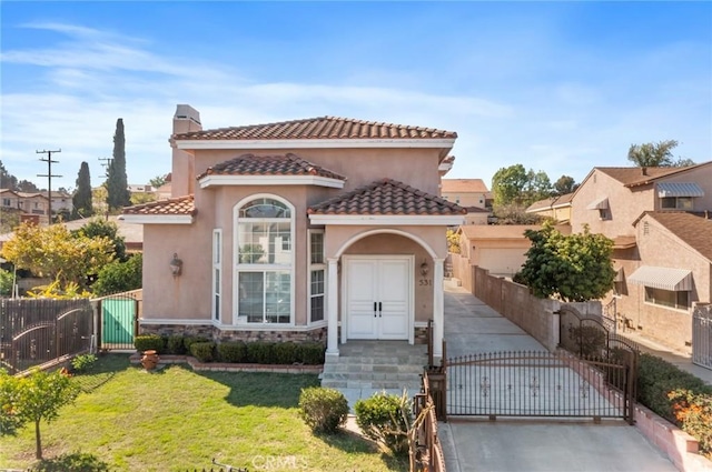 mediterranean / spanish home featuring a gate, a tile roof, a chimney, and stucco siding