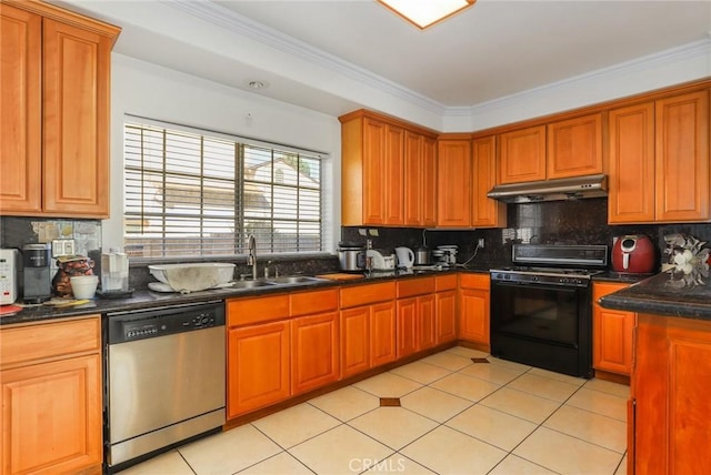 kitchen with dark countertops, stainless steel dishwasher, black range with gas stovetop, a sink, and under cabinet range hood