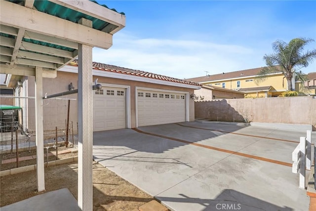 exterior space with driveway and fence