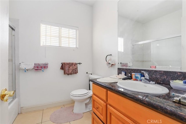 bathroom with toilet, shower / bath combination with glass door, vanity, and tile patterned floors