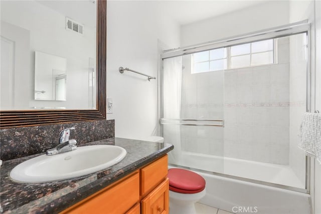 bathroom featuring bathtub / shower combination, toilet, vanity, visible vents, and tile patterned floors