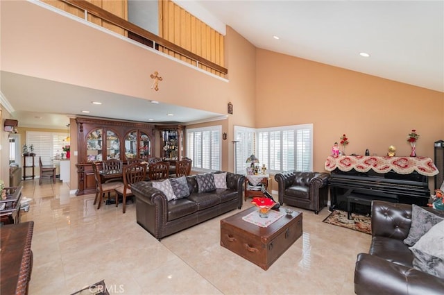 living area featuring crown molding, a high ceiling, and recessed lighting