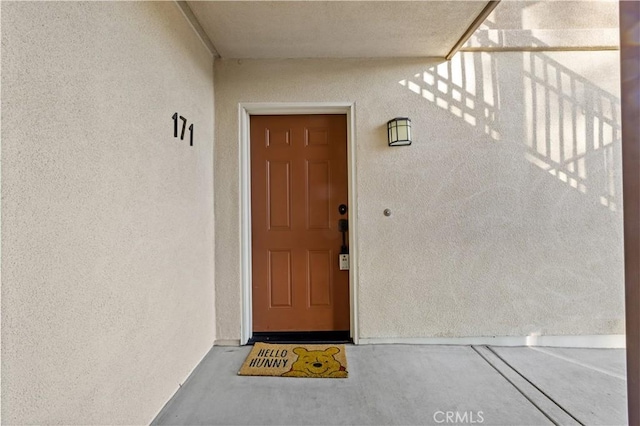 doorway to property with stucco siding